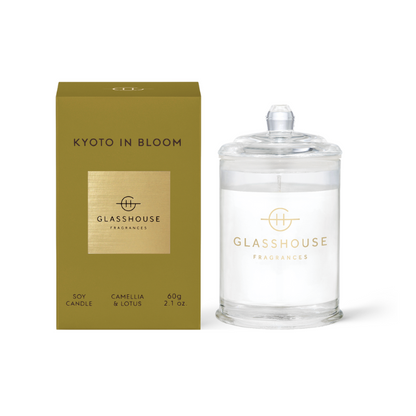 Kyoto In Bloom Triple Scented Candle with lid displayed next to the gold box against a white background