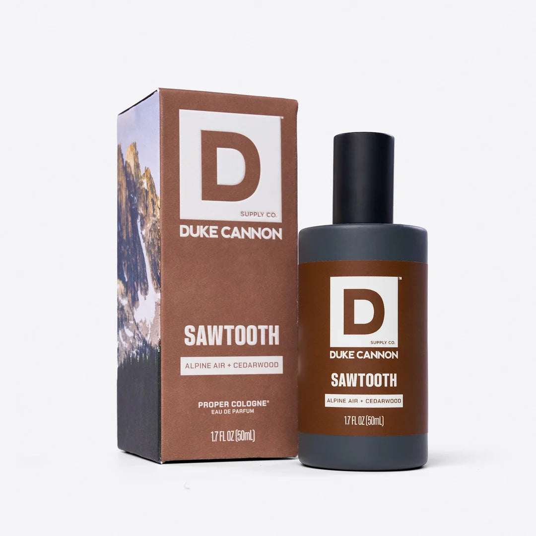 dark grey bottle of cologne, sawtooth fragrance, set next to it box packaging shown on a white background