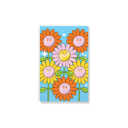 front cover of notebook with orange, yellow, and pink smiling flowers on it.