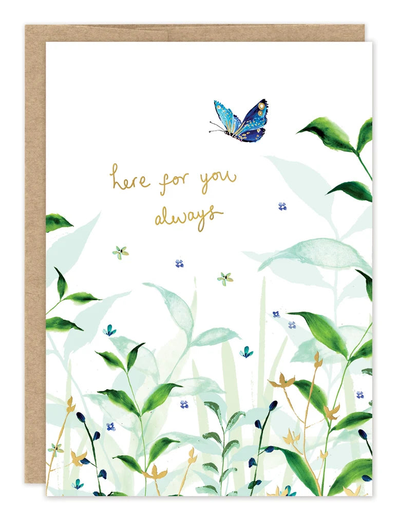 front of card featuring greenery and gold text