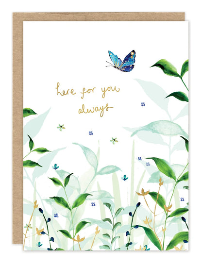 front of card featuring greenery and gold text