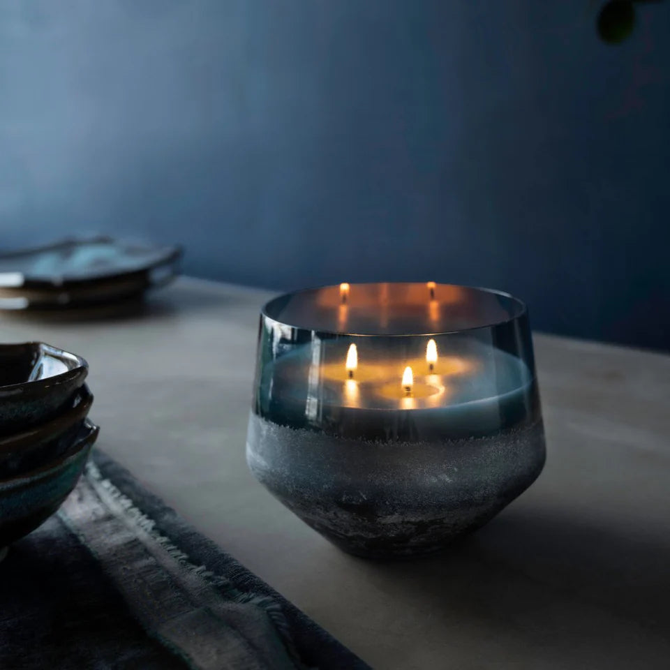 large baltic glass hidden lake candle lit and in a dark, decorated setting