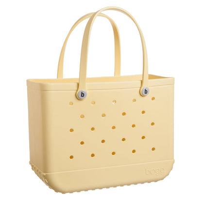 pale yellow bogg bag on white background.