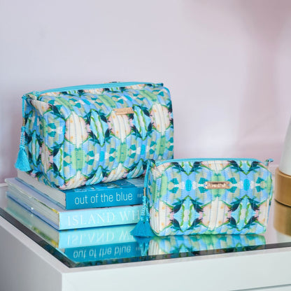 small and large island house cosmetic bags on a decorated setting
