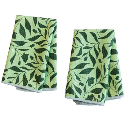 2 light green biggie towels with dark green foliage printed on them.