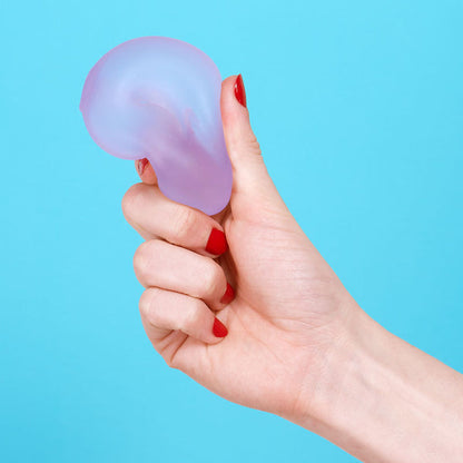 Hand holding a purple stress ball loop against a blue background