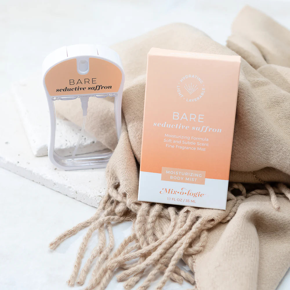 Bare Saffron body mist and packaging on a beige blanket