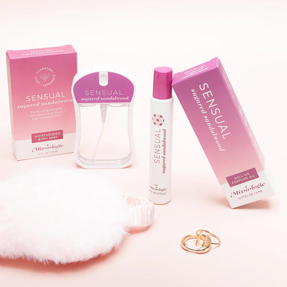 Sensual perfume products and other items arranged on a light background