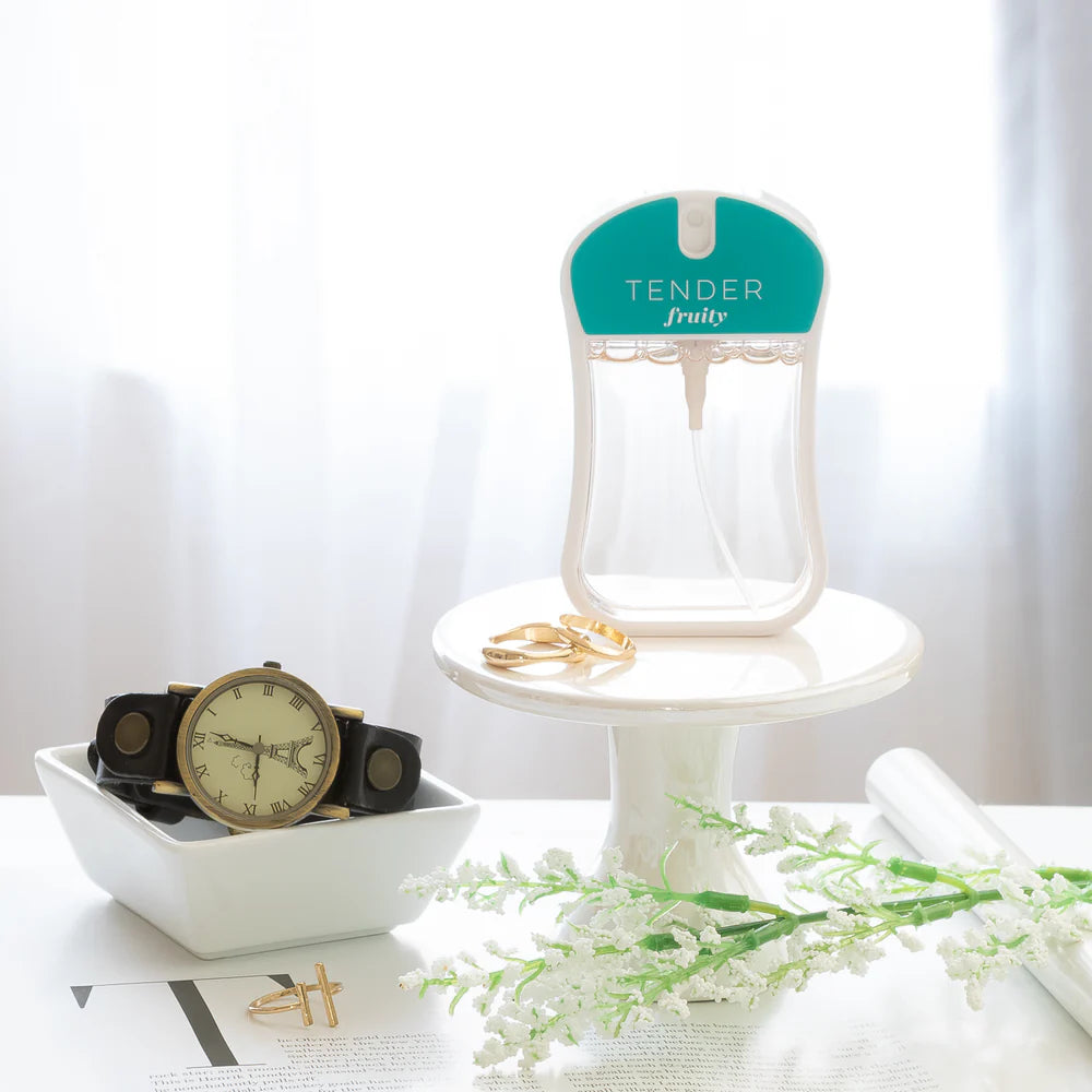 tender body mist with Jewelry stand with rings, watch, and flowers on a white surface