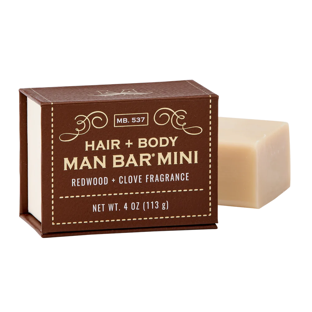 redwood and clove man bar mini ser next to its brown box packaging