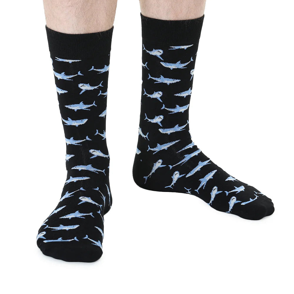Black socks with shark pattern worn by a person on a white background
