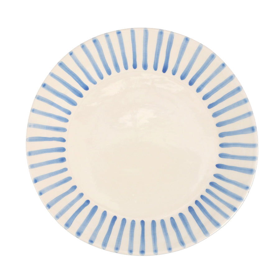 top view of modello dinner plate that is white with blue lines radiating around the rim.