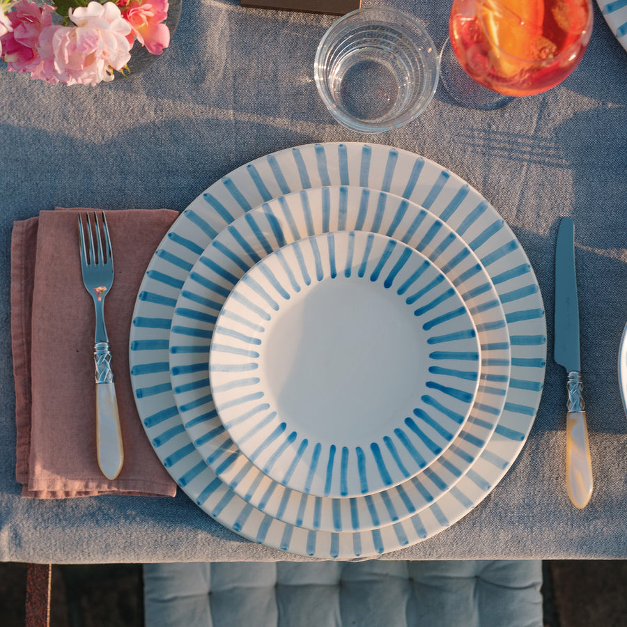 top view of modello pace setting on a table with glasses, linens, and silverware.