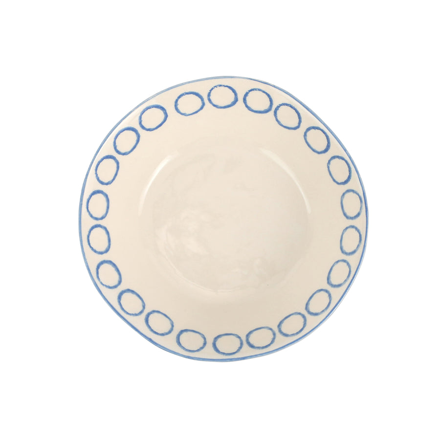 top view of modello pasta bowl that is white with blue circles along the inner rim.