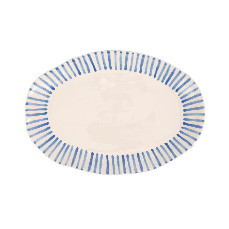 top view of modello oval plater that is white with blue lines radiating around the rim.