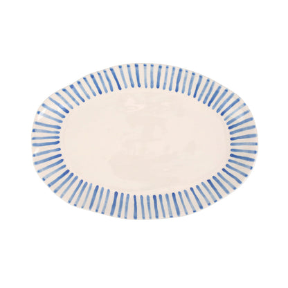 top view of modello oval plater that is white with blue lines radiating around the rim.