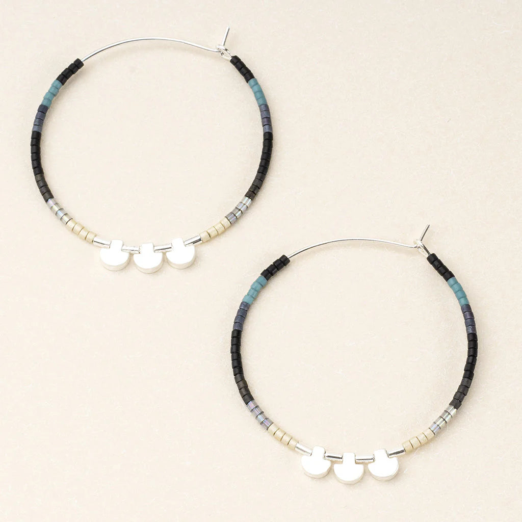 hoop earrings beaded with beads in a shades of black and blue.