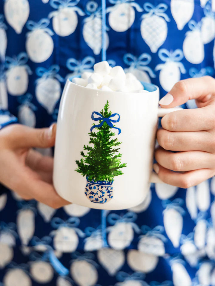 Person holding festive and fancy mug with marshmallows in it.