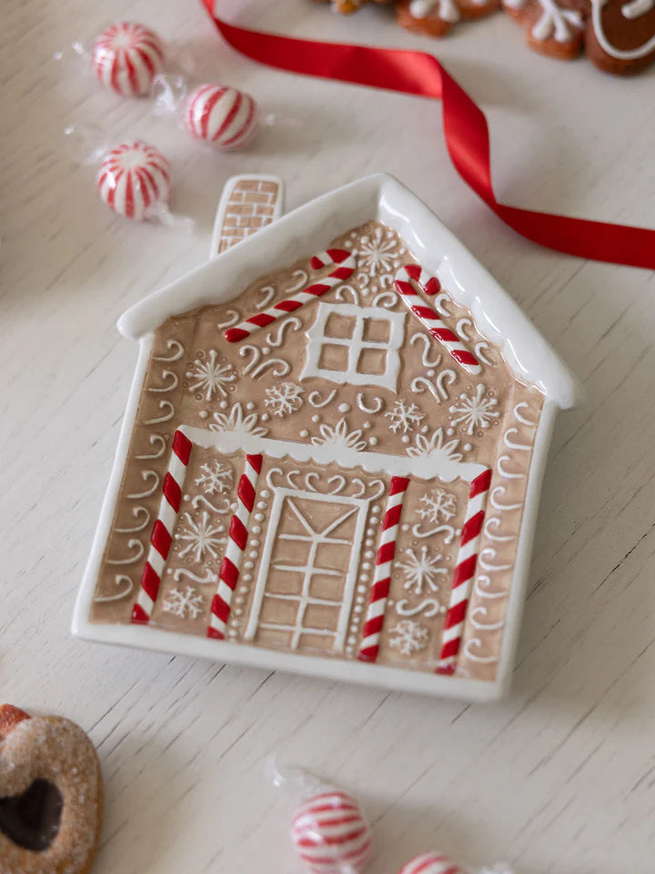 angled view of Gingerbread House Appetizer Plate set on a table.