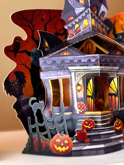 close-up o pop up haunted house card showing details and pumpkins on the porch