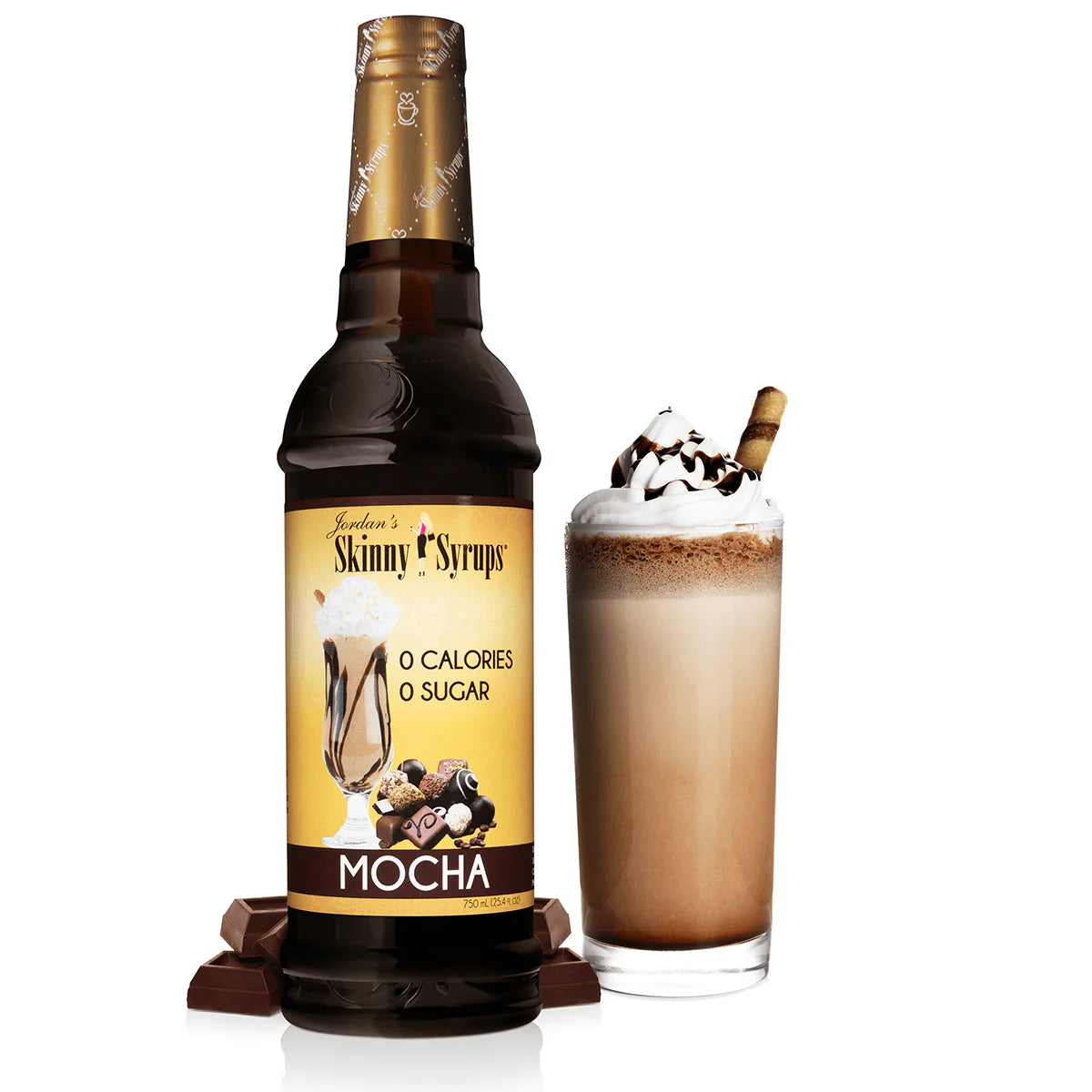 bottle of mocha skinny syrup set next to a frozen coffee beverage topped with whip cream.