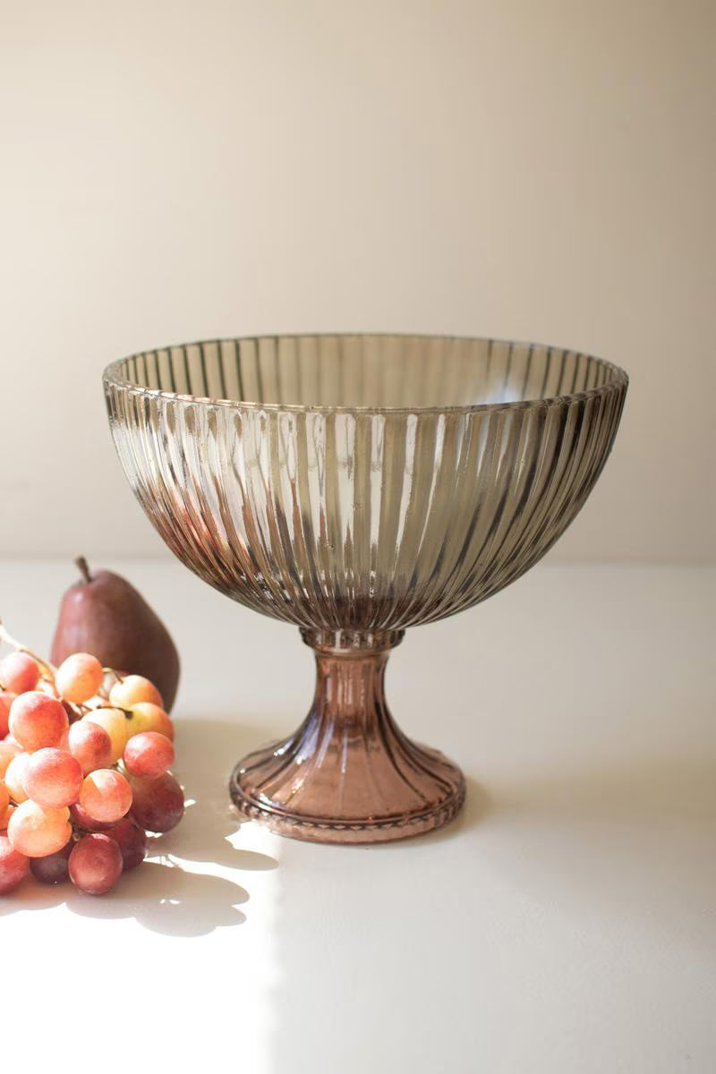 pale purple Ribbed Glass Compote set on a counter with fruit next to it