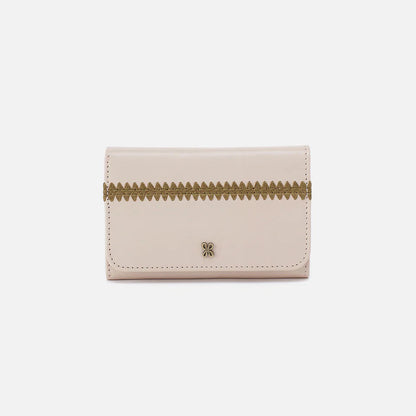 front view of pale flax  jill wallet that is off-white wallet with green trim