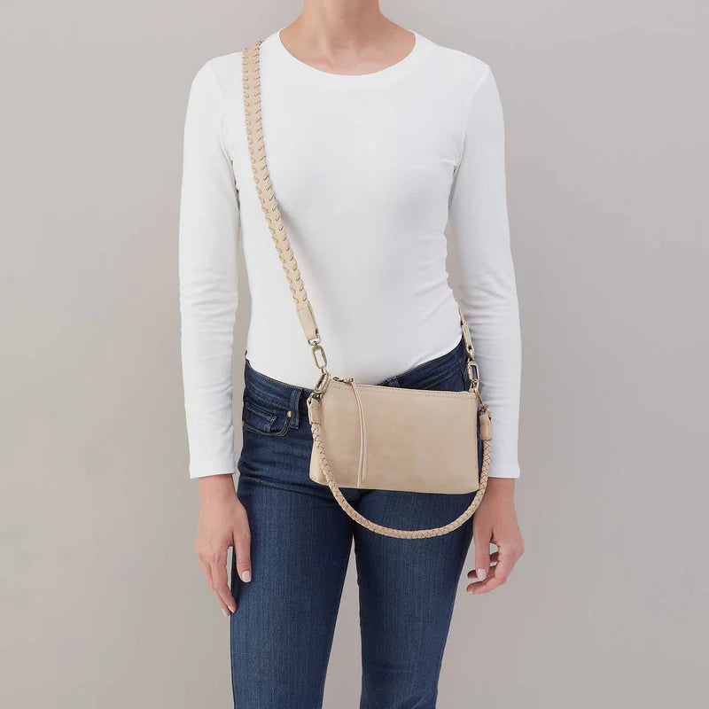 model wearing a Darcy crossbody with braided strap in the taupe color called frosted pearl