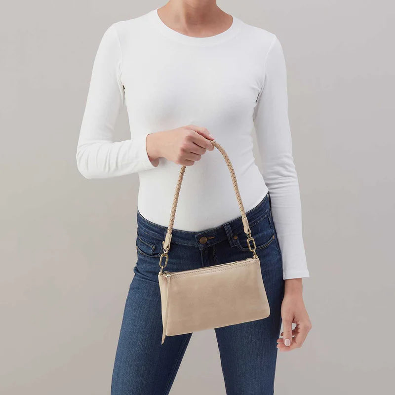 Darcy crossbody with braided strap in the taupe color called frosted pearl being held by the small braided strap