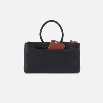 back view of black Sable Crossbody with gold details with phone in pocket