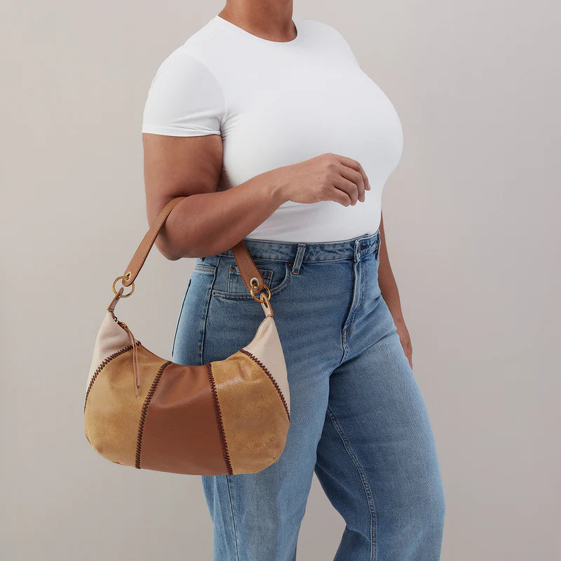 person holding the timber brown opal shoulder bag