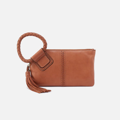 Brown leather clutch with braided handle and tassel on a white background