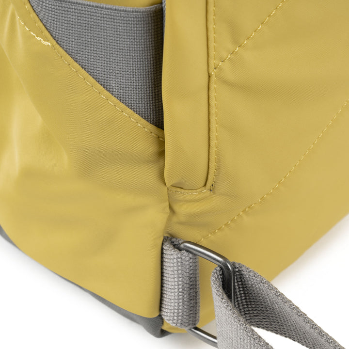 close of yellow canfield b backpack's strap attachments.