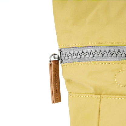 close of yellow canfield b backpack's zipper pull.