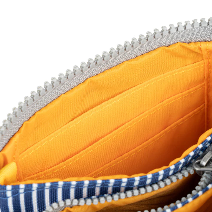 close-up of unzipped top zippers showing interior card slots.