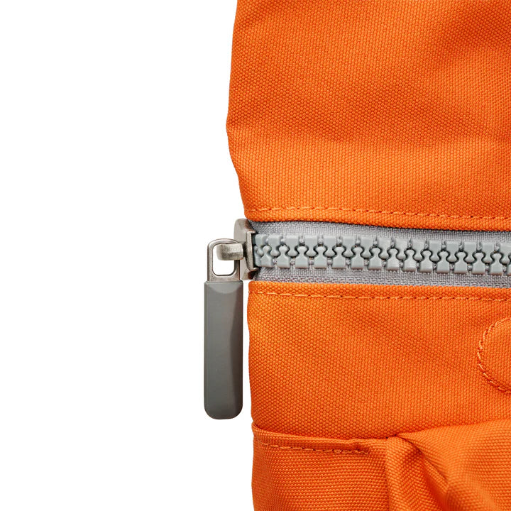 Close up of zipper pull on Orange, Richmond backpack.