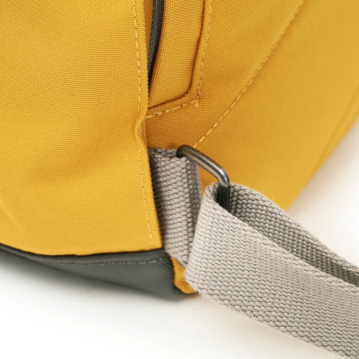 close-up of shoulder strap attached to backpack.