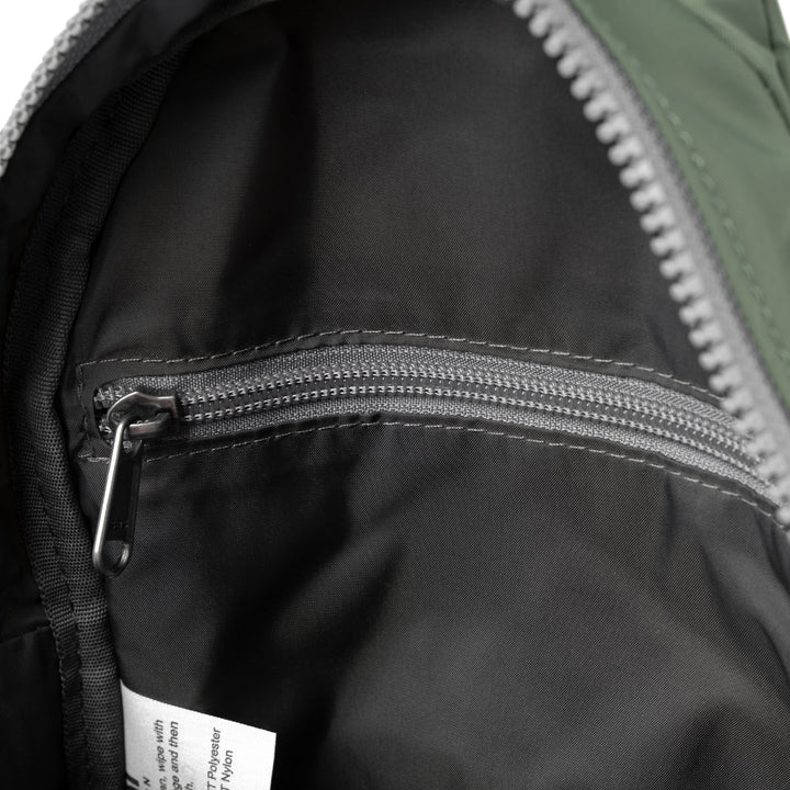 interior view of Willesden sling bag showing black lining and inner zip pocket.