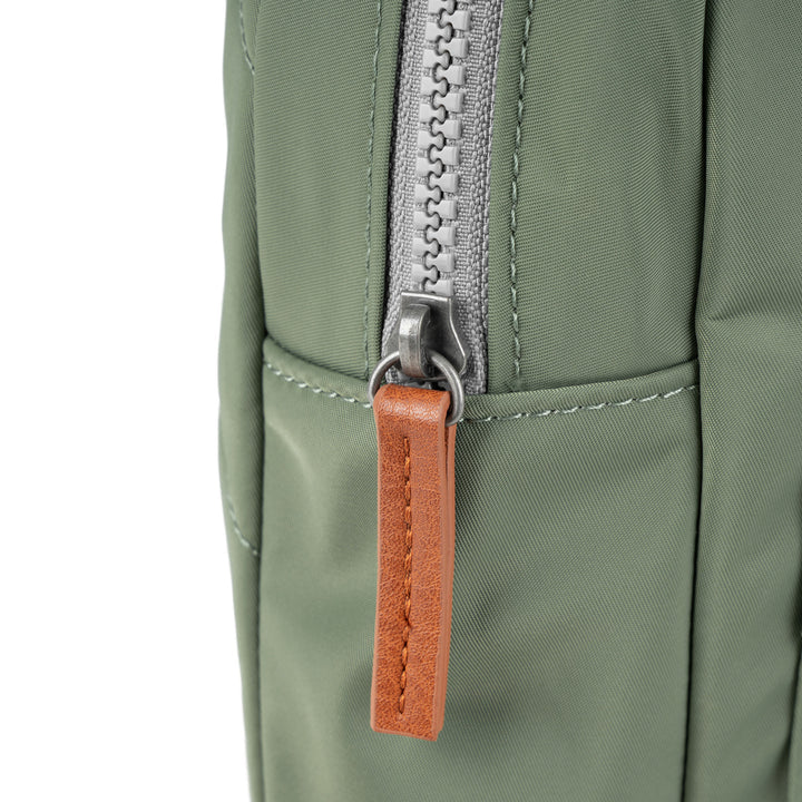 close-up of side zipper with brown pull.