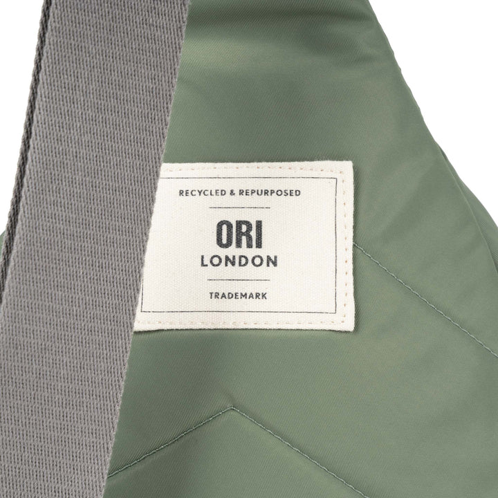 close-up of Ori London patch on back of sling bag.