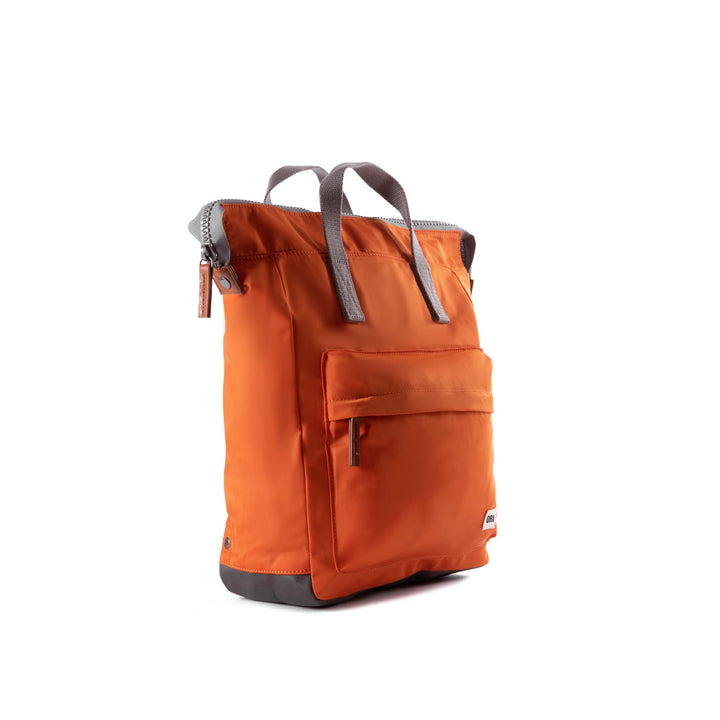 side view of orange bantry b backpack.