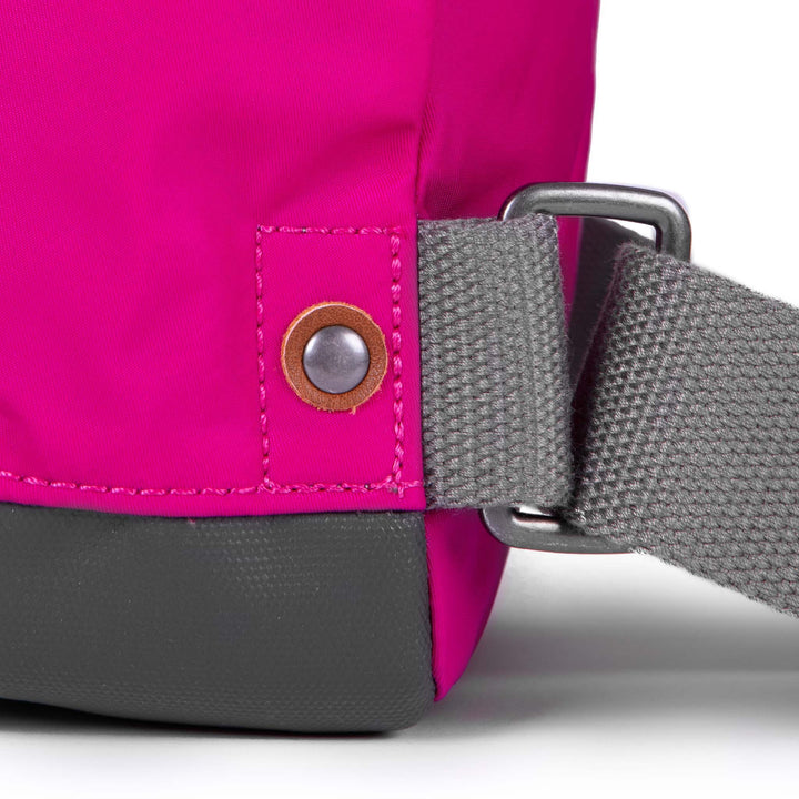 close of pink bantry b backpack's strap attachments.