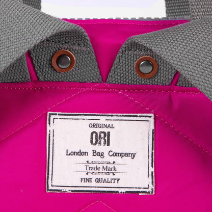 close of pink bantry b backpack's ori logo tag.