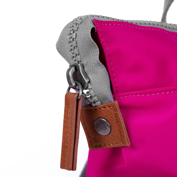 close of pink bantry b backpack's zipper pull.