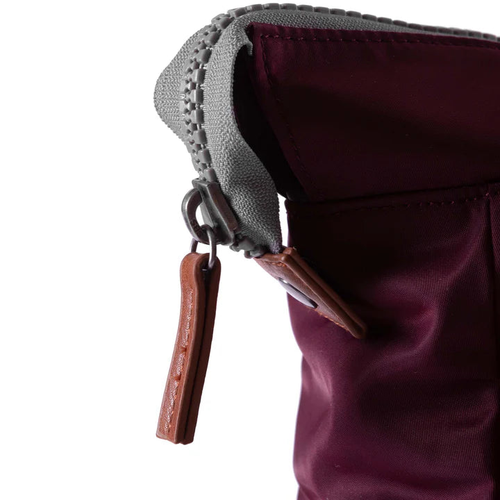 close of plum bantry b backpack's zipper pull.