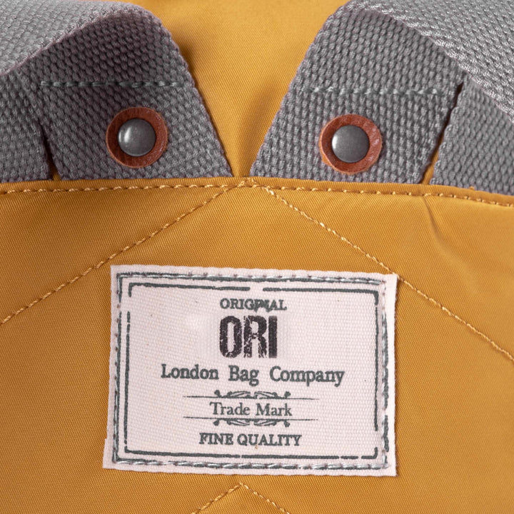 close-up view of ORI logo tag sewn on backpack.