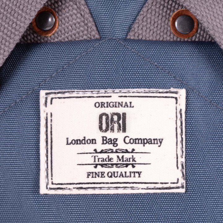close-up view of ORI logo tag sewn on backpack.