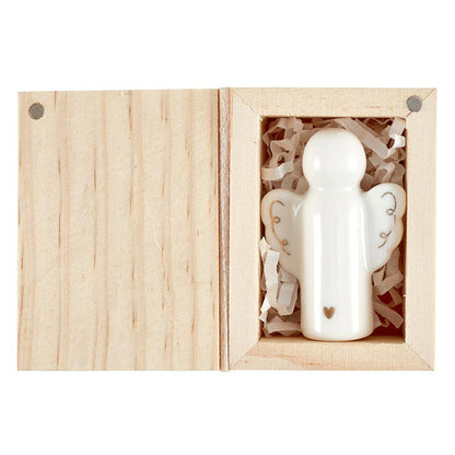 ceramic angel set inside a wooden box.