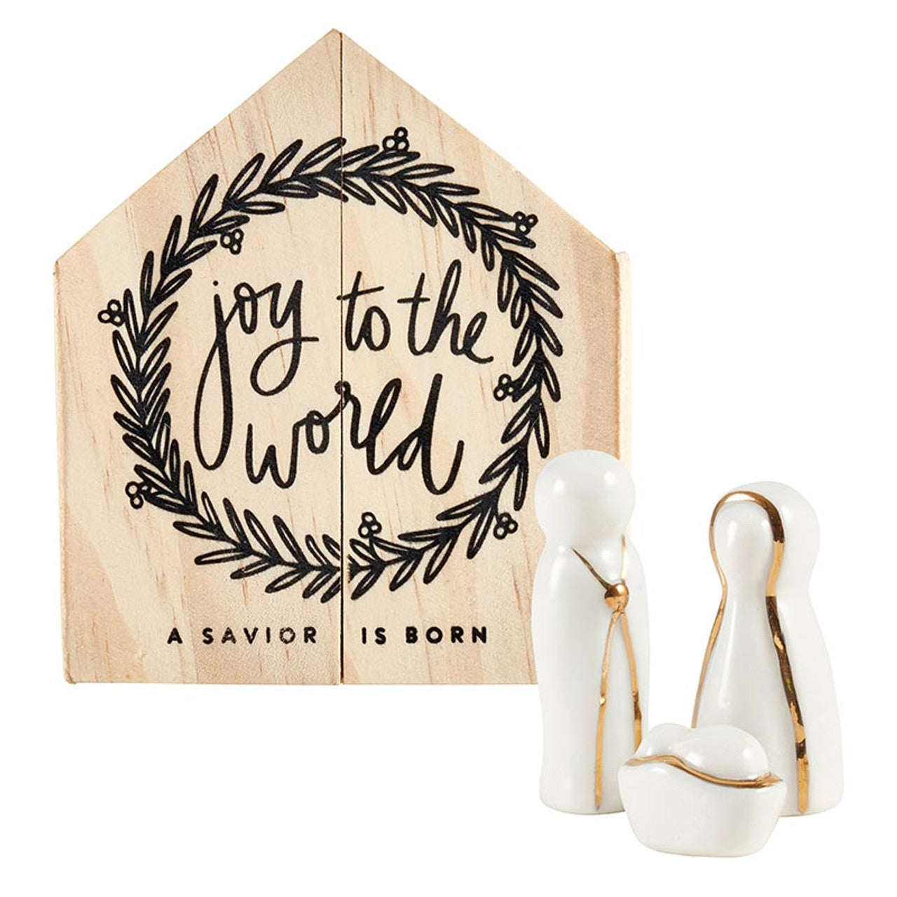 Ceramic figures of Mary, Joseph, and baby Jesus in the manger with a wooden box printed with joy to the world in the background.