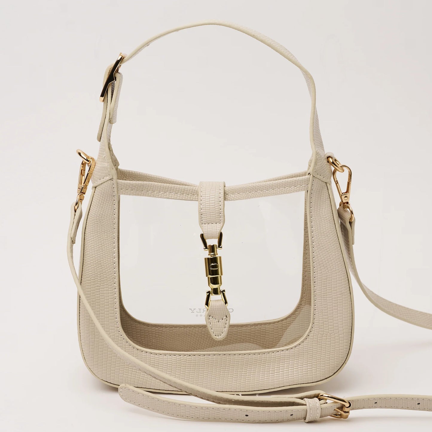 clear handbag with ivory trim and short strap and and longer cross body strap and gold hardware